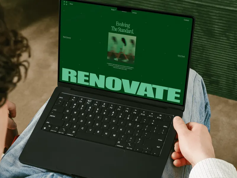 Renovate website on a laptop: the word RENOVATE set large on a deep green page