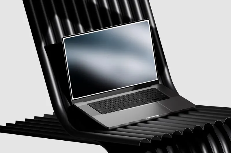 Supaminds website on a laptop resting on black ribbed tubes, a soft grey gradient on its screen