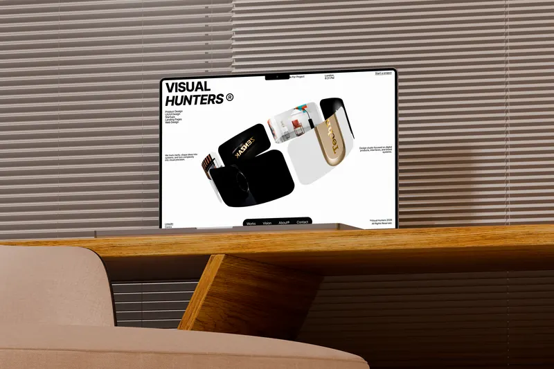 Visual Hunters® website on a laptop on a wooden sideboard in front of window blinds